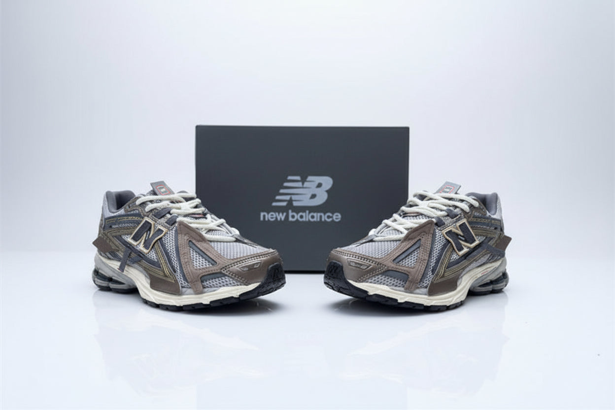 Pair of New Balance running shoes on a concrete surface with a box in the background.