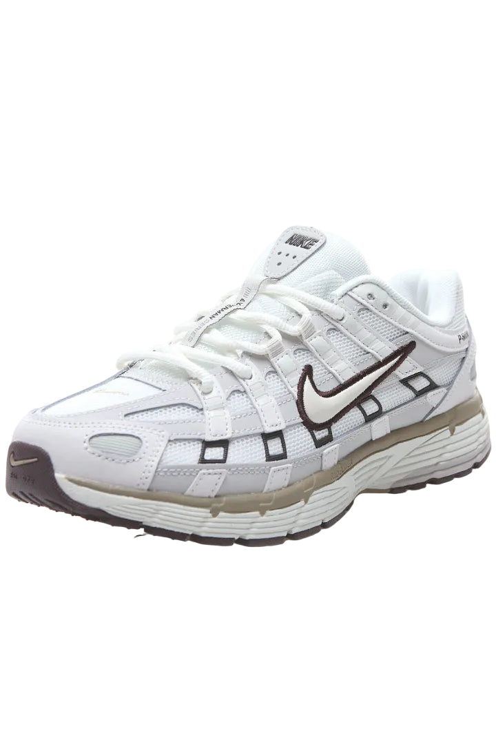 White running shoe with brown accents on a white background