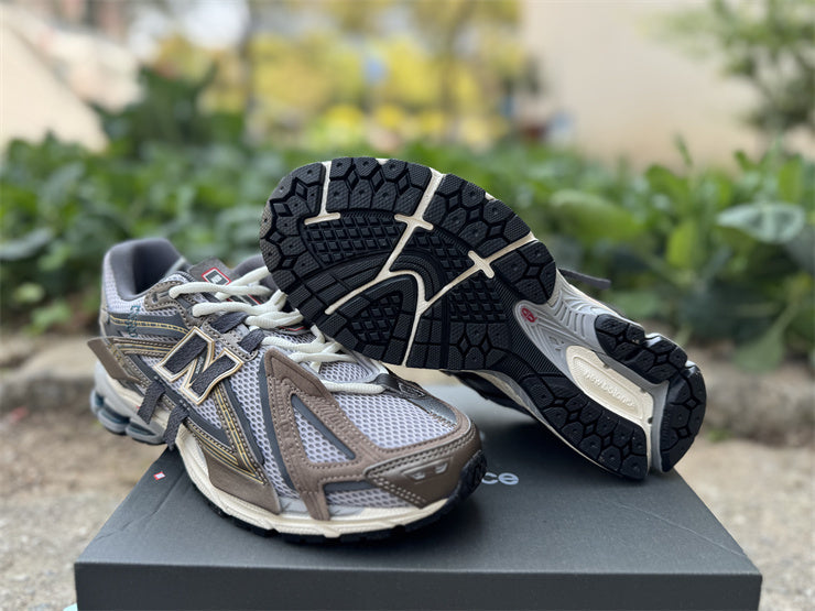 Pair of New Balance running shoes on a concrete surface with a box in the background.