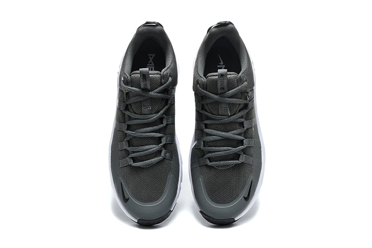Gray athletic shoe with white sole on a white background