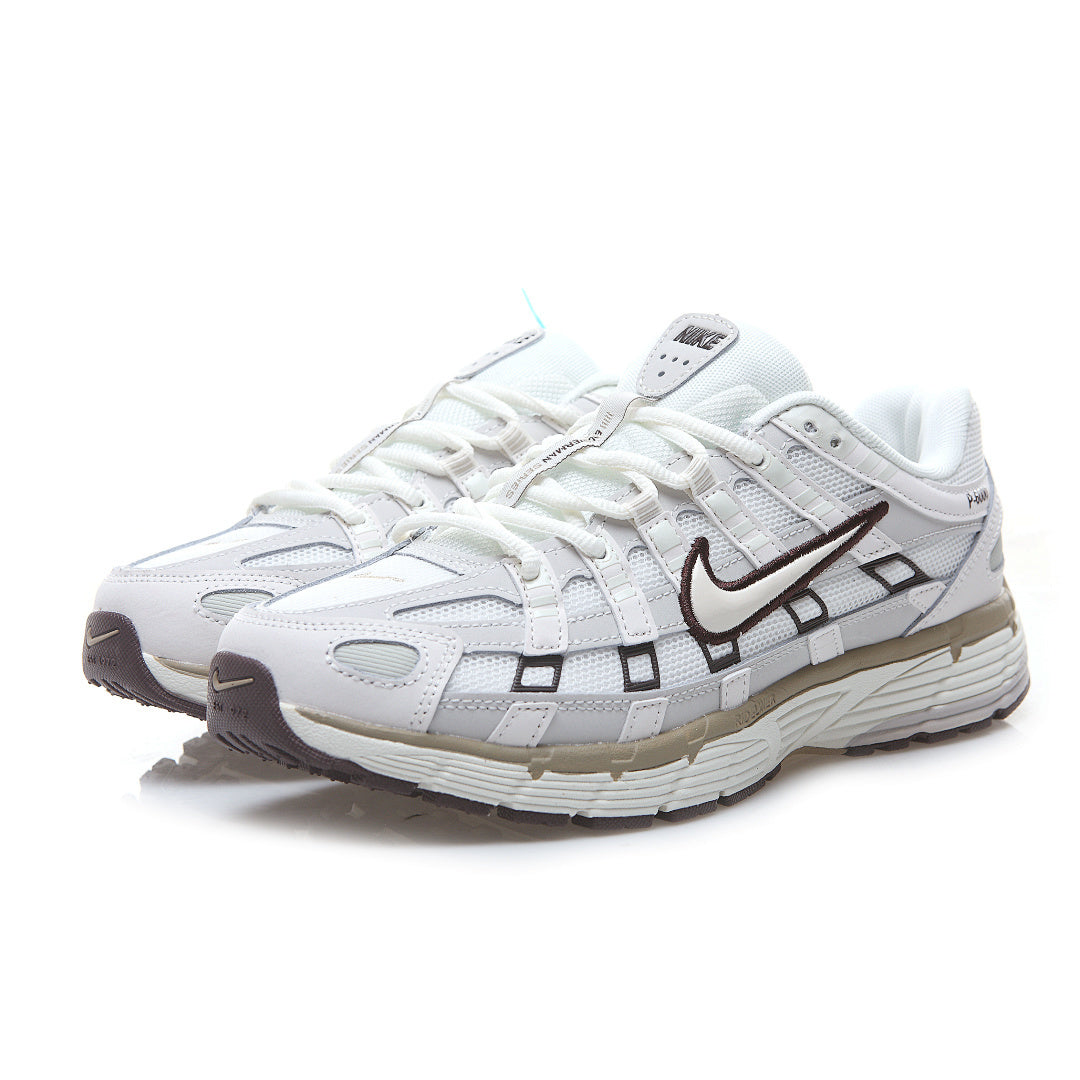 White running shoe with brown accents on a white background