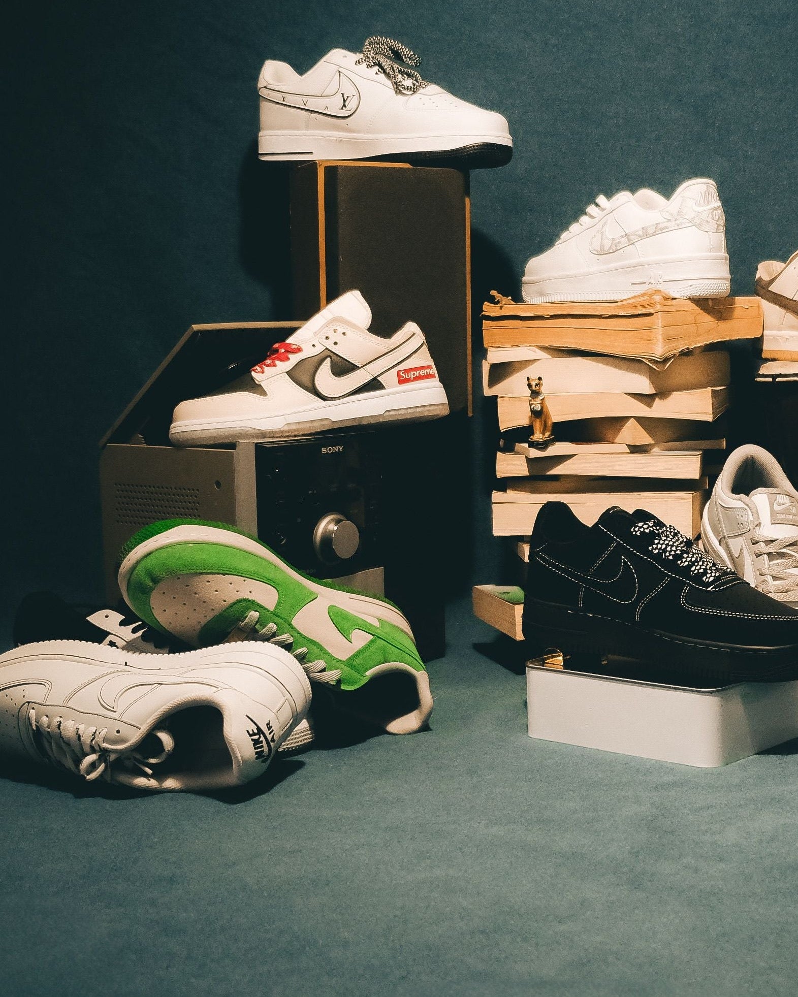 Collection of sneakers on various stands against a dark background